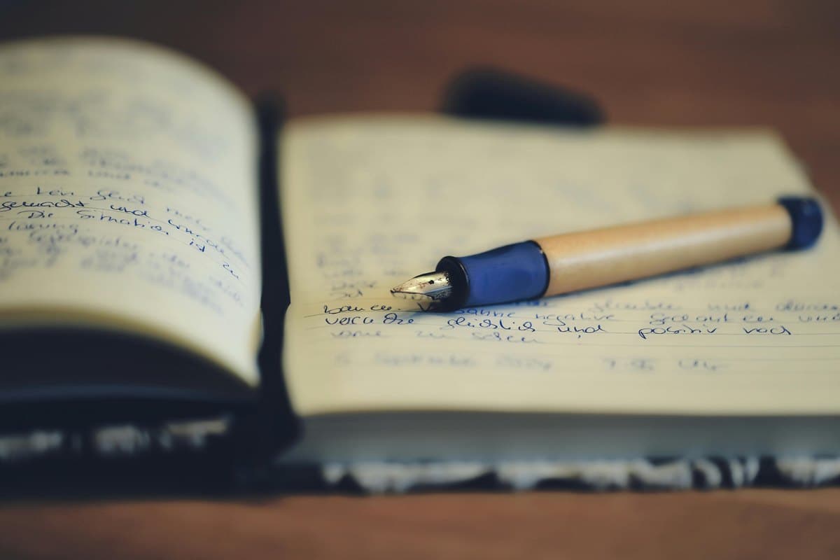 An open notebook with a pen