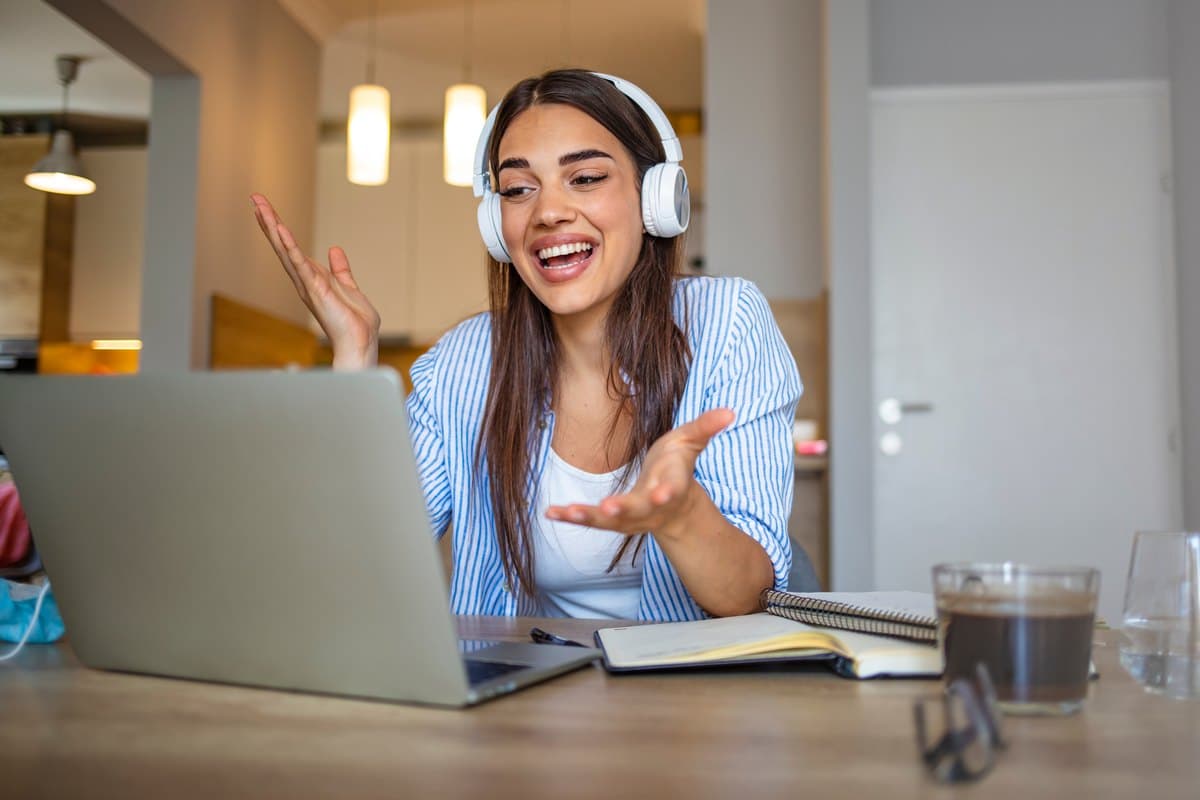 A person with headphones at a laptop